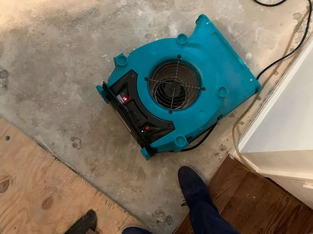 Air mover drying subfloor during Commercial Water Damage Restoration in Fredonia